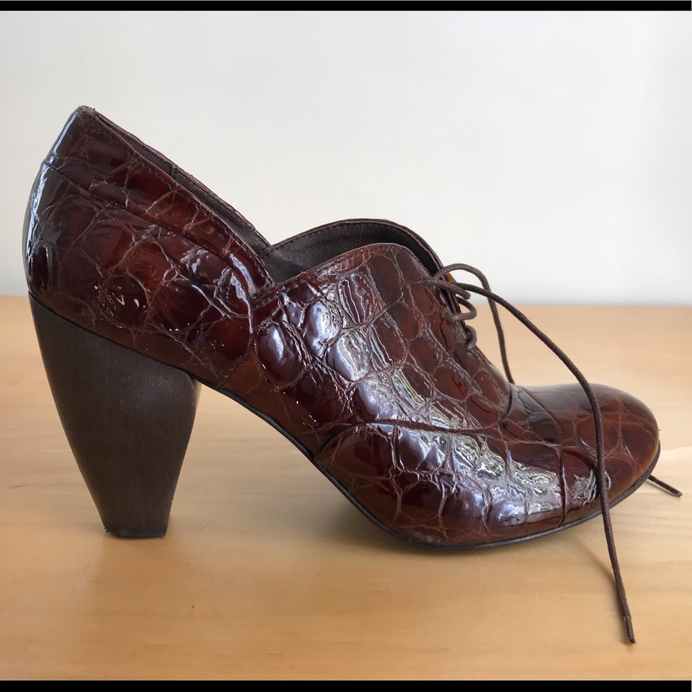 Coclico brown patent leather booties.